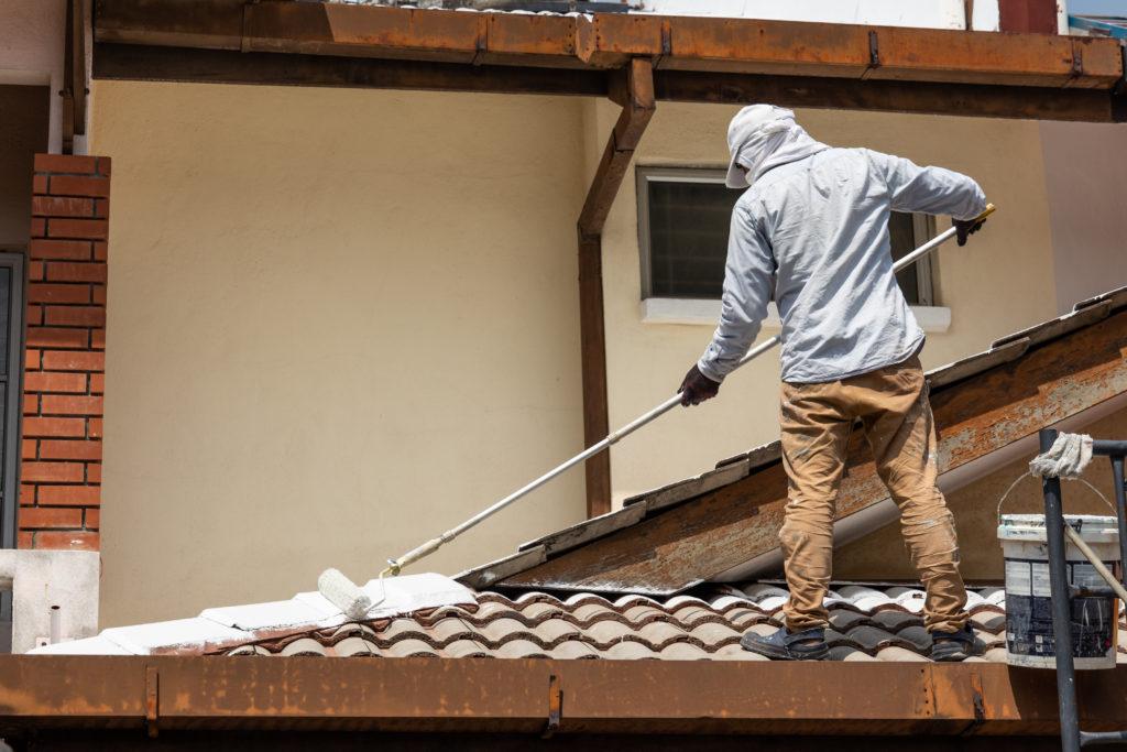 Worker adding undercoat foundation